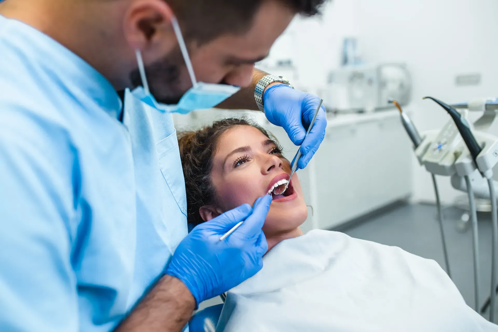 Dentist examining a patient’s teeth during a dental checkup.
